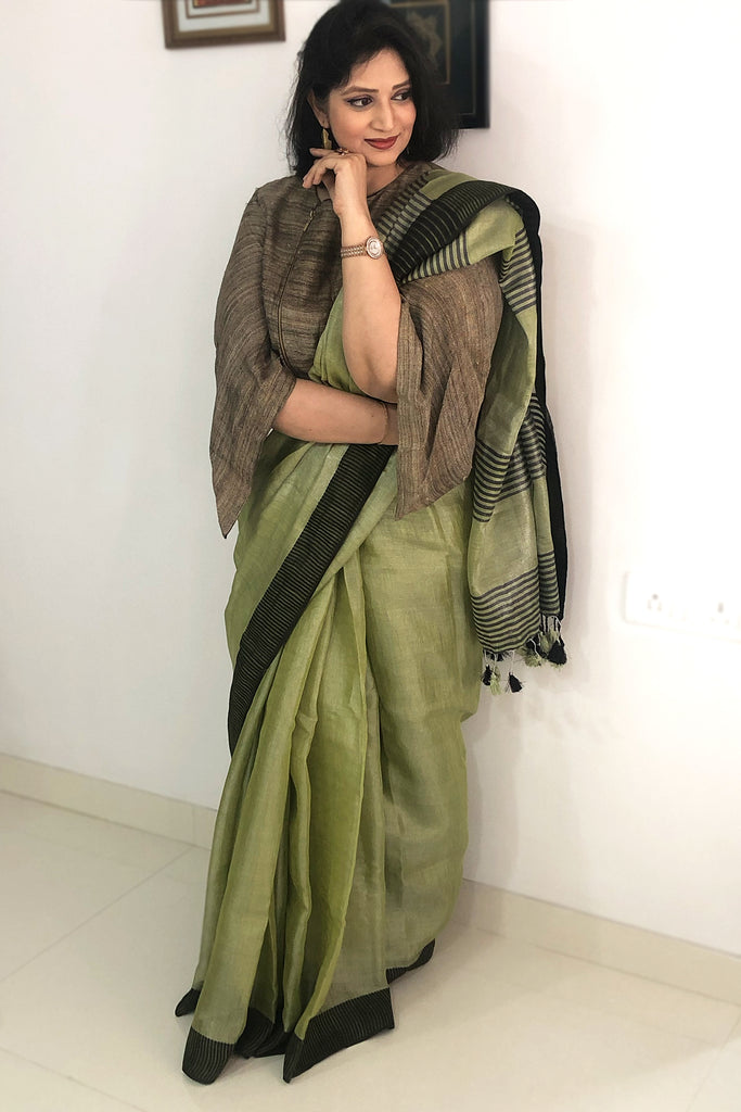 Sea green linen saree with checks and embroidered butti only on Kalki